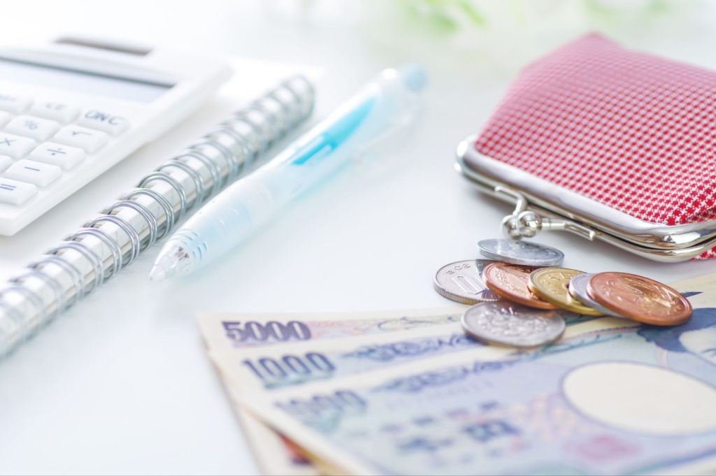 財布とお金、文房具が乱雑に置いてある