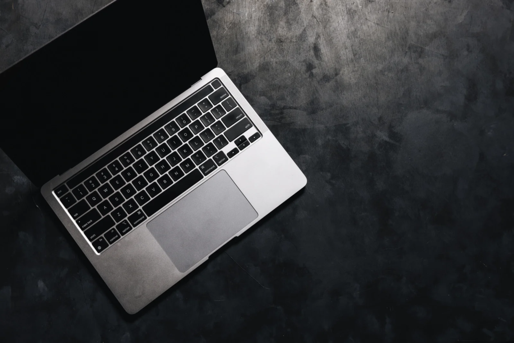 黒い床の上にノートパソコンが置いてある