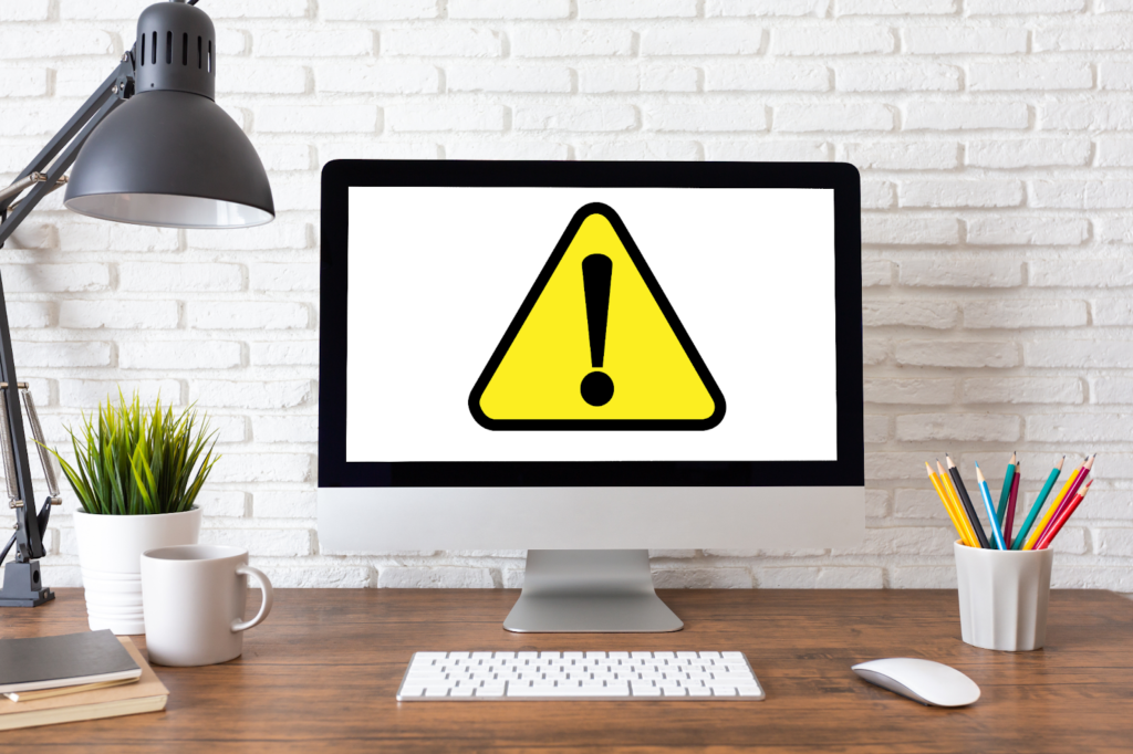 パソコン画面に三角に！マークの警告イラストが表示されている